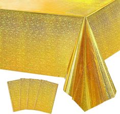 the table cloth is shiny gold and it has five placemats on each side