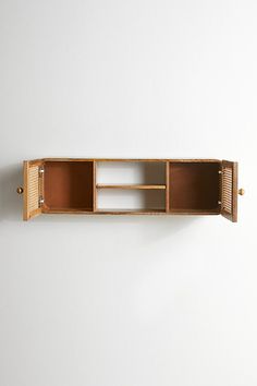 a wooden shelf with two open doors on it