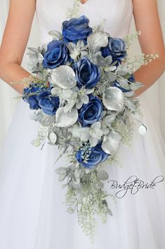 a bride holding a blue and silver bouquet