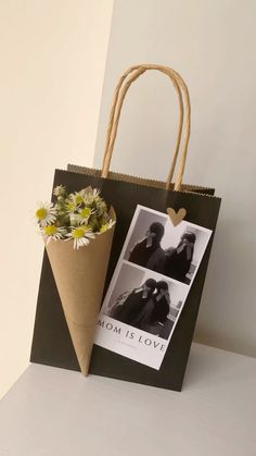 a brown paper bag with two pictures on it and a flower in the bottom left corner