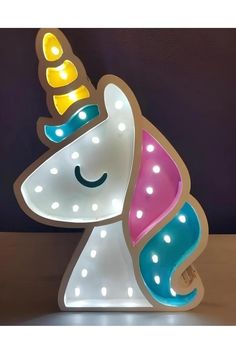 a light up unicorn with a smile on it's face