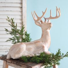 a wooden deer statue sitting on top of a table