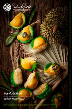 an advertisement for durian fancy soaps with dragon fruit and bamboo fan on wooden background