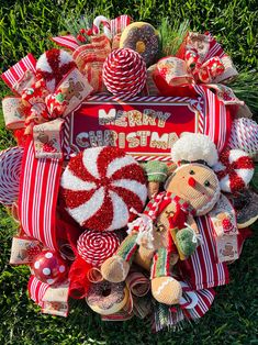 a christmas wreath made out of candy canes, candies and other holiday decorations