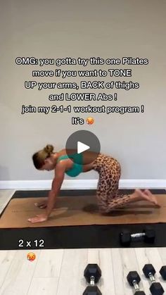 a woman doing a yoga pose on a mat with dumbbells in front of her