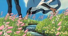 an animated image of two people standing on top of a hill with flowers in the foreground