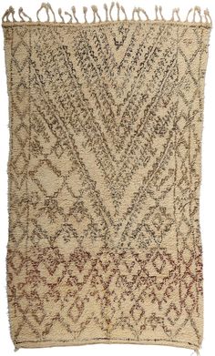 an old rug with fringes on it