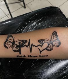 a woman's arm with two butterflies on it and the words faith hope love