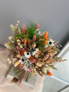 a vase filled with lots of different types of flowers