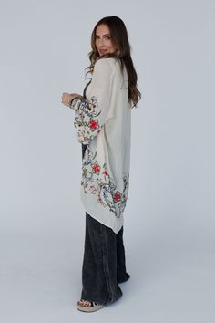 Nothing is more fun than a kimono covered in floral! This perfect layering piece features a sheer fabric in a longline silhouette with accents of crochet florals in multicolors along the hem and wide sleeves! *Due to lighting and differences in monitors, actual colors may vary slightly from what appears online. Model is 5'8" and wearing a size Small. Approximate measurements are as follows: ONE SIZE: Width: 46", Length: 38", Sleeve length: 14" 65% Viscose, 35% Polyester Hand wash cold, Lay flat Spring Floral Embroidered Kimono With Kimono Sleeves, Spring Floral Embroidery Kimono With Kimono Sleeves, White Hippie Kimono For Spring, Oversized Spring Tunic Cover-up, Flowy Long Sleeve Spring Kimono, White Hippie Cover-up For Spring, Hippie White Cover-up For Spring, Hippie Long Kimono For Spring, Long Hippie Kimono For Spring