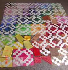 a colorful quilt is laying on the floor