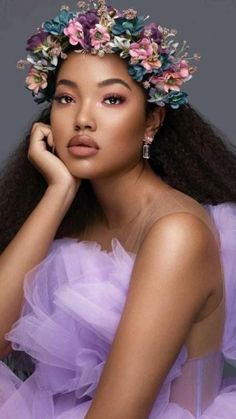 a woman with long hair wearing a purple dress and a flower crown on her head