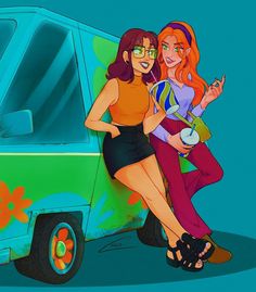 two women standing in front of a van