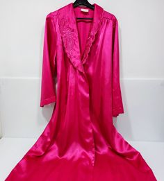 This vintage hot pink long satin robe from Liboria Creations is perfect for those special occasions. It elegantly drapes around your body, made with luxurious high quality satin fabric and is available in size large. Its classic design is an ideal fit for any woman and makes an excellent gift to show kindness and appreciation to your loved one. Stylishly structured, the robe has classic elements with a unique pink hue that will make you stand out. Get this made-in-Canada product now and experien Pink Long Sleeve Satin Robe, Pink Satin Finish Sleepwear For Wedding Night, Long Pink Silk Robe, Pink Silk Long Sleeve Sleepwear, Pink Silk Sleepwear For Evening, Pink Satin Finish Robe For Wedding, Long Pink Robe For Wedding, Long Pink Robe For Wedding Night, Pink Satin Robe With Satin Finish