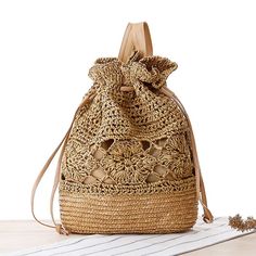 a straw bag with an intricate design on the front