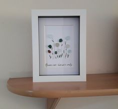 there is a white frame with some flowers on it and the words flowers are not native