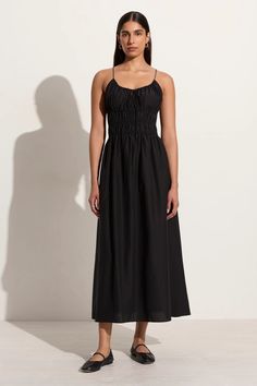 In luxe silk-cotton, the Carinna Midi Dress in Black features a round drawstring neckline and slender adjustable straps designed to be tied at the front. The shirred waist offers stretch and pull-on ease, and gives way to a floaty, lightweight mid length skirt. Rendered in black for timeless appeal, the Carinna is an easy-wearing style for any occasion. Italy Vacation Outfits, Italian Summer Outfits, Flirty Tops, Black Linen Dress, Drawstring Neckline, Italy Outfits, Wearing Style, Maxi Dress Sale, Midi Dress Black