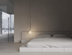 a large bed sitting in a bedroom next to a wall mounted light on it's side