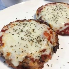 two pieces of pizza on a plate with cheese and tomato sauce, sprinkled with parmesan