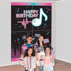 three girls standing in front of a happy birthday sign with music notes on it and the words happy birthday