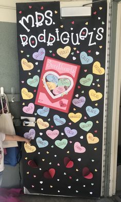 a black door with hearts on it and the words mrs poopiepie's