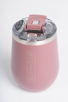 a pink cup with a camera attached to the top and bottom lid, on a white background