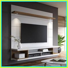 a large flat screen tv mounted to the side of a wall in a living room