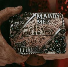 two hands holding up a card that says marry me and mrs williams