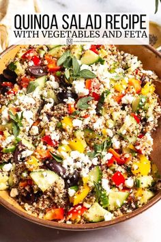 quinoa salad recipe with vegetables and feta in a bowl on a table