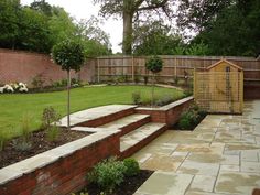 an outdoor garden with steps leading to the back yard