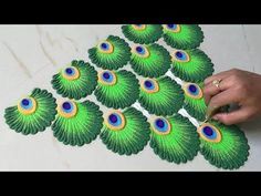 a person is making peacock decorations on the floor