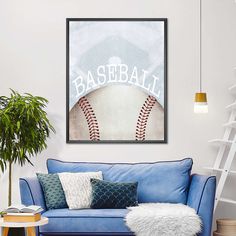 a blue couch in a living room with a baseball poster on the wall above it