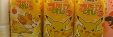 four cans of pokemon juice on display in a store