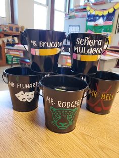 five black buckets with mr and mrs brucaca's name on them