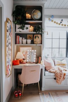 a room with a desk, bookshelf and shelves filled with pictures on it