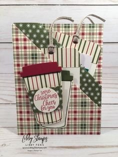 a christmas card with coffee mugs on it and tags hanging from the top of them