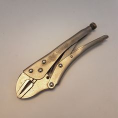 an old pair of pliers on a white surface