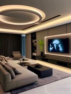 a modern living room with a large flat screen tv mounted on the wall and couches