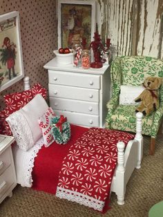 a dollhouse bedroom with red and green furniture, teddy bear on the bed, white dresser