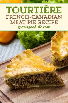 two pieces of meat pie sitting on top of a cutting board