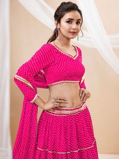 Introducing a charming pink georgette lehenga that is perfect for enhancing your festive wardrobe. This exquisite ensemble features a lehenga adorned with leheriya printed work and beautiful lace detailing, creating a visually stunning and elegant look. The semi-stitched lehenga allows for a customizable fit up to 42 inches, ensuring both comfort and style for every occasion. The soft, pastel pink color, paired with intricate patterns, makes this outfit a perfect choice for events, functions, fe Pink Georgette Lehenga, Engagement Gown, Pastel Pink Color, Lehenga Crop Top, Georgette Lehenga, Lehenga Choli Wedding, Floral Lehenga, Stitched Lehenga, Party Wear Lehenga Choli