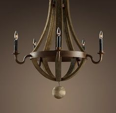 a wooden chandelier with candles hanging from it's center and two lights on each side