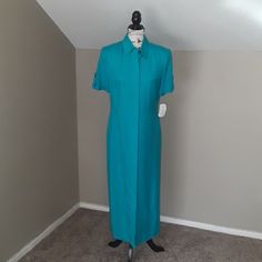 Nwt, Beautiful Size 8, Fully Lined With Shoulder Pads. Clear Button Closure From Top To Bottom, 100% Rayon. Side Pockets, Button Cuffs On Sleeves, Small Tie In Back. Length 53", Pit To Pit Approx 19" Flat. Very Nice Weight. The Dress Looks Blue In Some Of The Photo's, But It's A Teal Color Fitted Short Sleeve Dresses With Covered Buttons, Blue Fitted Maxi Length Shirt Dress, Formal Short Sleeve Dress With Buttons, Formal Short Sleeve Buttoned Dress, Green Fitted Button-up Maxi Dress, Formal Green Shirt Dress, Formal Fitted Shirt Dress With Covered Buttons, Classic Fitted Maxi Dress With Short Sleeves, Classic Fitted Short Sleeve Maxi Dress