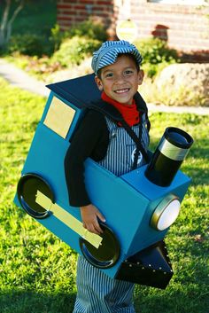 a young boy dressed up as a train conductor