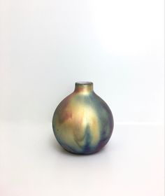 a small vase sitting on top of a white table