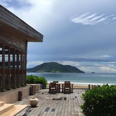 a wooden deck overlooking the ocean and mountains