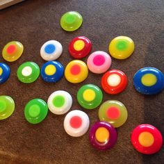 many different colored buttons laying on the floor