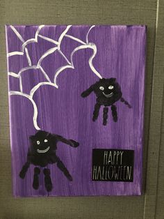 a purple painting with two black hands and spider webs on it, in the shape of a handprint