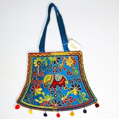 This Is A Lovely, Bright Embroidered Shoulder/Handbag From India. It Is Very Colorful With A Base Of Blue And Needle Work Of Green, Red Purple, Yellow, Magenta, Orange And Silver Threading Holding And Connecting The Flowers And Swirls Together And Surrounding A Lucky Elephant. There Are Also Tiny Mirrors To Reflect The Light. The Back Is Solid Blue Silk (No Embellishment). The Inside Has One Small Zippered Pocket In A Large Compartment And Is Fully Lined In A Matching Light Cotton. The Bag Zips Tiny Mirrors, Embroidery Shoulder, Orange And Silver, Indian Blue, Frye Bags, Lucky Elephant, Tan Bag, Tapestry Bag, Quilted Handbags