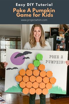 a woman holding up a pumpkin game for kids